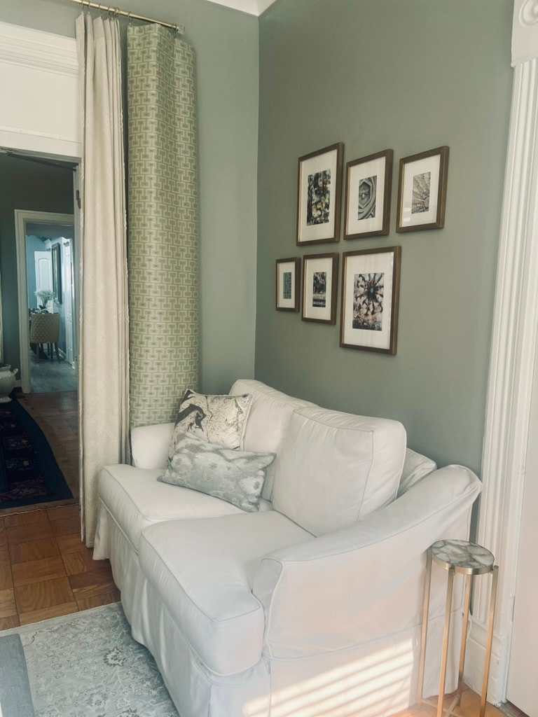 Gallery wall with white loveseat